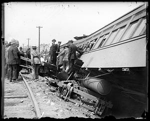 People by the side of an overturned railroad car