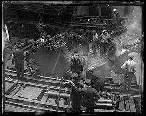 People gathered around debris from a wreck, probably a piece of a train