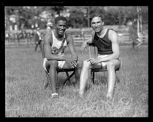 DeHart Hubbard sitting next to an unidentified athlete