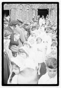 A group of children coming out of a church after their first Communion