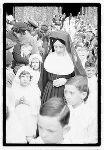 A group of children coming out of a church after their first Communion