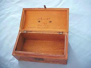Empty wooden box with inscription