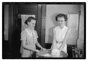 Women doing laundry with a washing machine