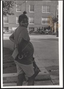 A woman posing with hands on her hips in Newtowne Court