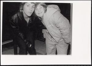 Photography teacher, Susan Richards, and a young girl wearing jackets and posing