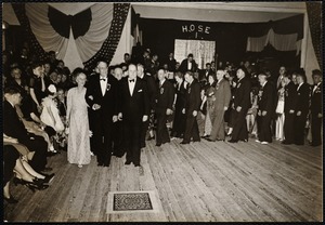 Chief of firedept. Dr. + Mrs. W. B Segur leading grand march. (The man on Segur's left is McEnelly leader of the orch.)