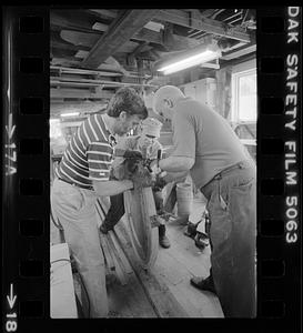 Men working in Pert Lowell's boat shop