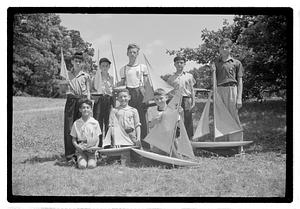 Boys posing with model sailboats