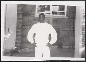 Young man wearing white sweatshirt with hands on hips