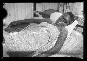 A woman lies down in a bed