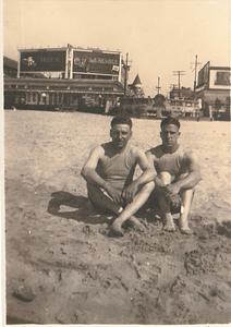 Nathan L. Hill and R. S. Boston in swimming attire on unknown beach