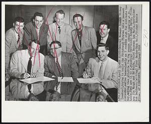 New Blood - General Manager Branch Rickey (center), trying to build the Pittsburgh Pirates into a pennant contender, smiles benevolently as 7 rookies sign Buc contracts today, making them eligible for the season opener tomorrow at St. Louis. They are (l to r, standing) Outfielder Brandy Davis, Pitchers Jim Waugh and Ed Wolfe, Third Baseman Lee Walls, Outfielder Bob DelGreco; (sitting) First Sacker Dick Hall, Pitcher Ronnie Kline.