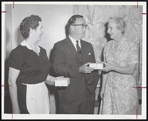 Gold Watches are presented to Agatha Doyle of Cambridge and Mae Connolly of Boston by Karl Adams, Jr., center, president of Smith House, in recognition of their 20 years service at Cambridge restaurant.