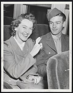 'Here's Hoping', says Cadet Lorraine Lewis, as she crosses her fingers to assure her luck will hold and she will reach Guilford, Me., by train. Miss Lewis and Pfc. Donald Northrup of Portland, were on one of the first trains to leave North Station after the five-day truce in the railroad dispute was announced.