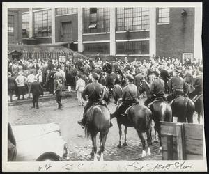 Mounted police are standing by at a Standard Oil Refinery at Cleveland as members of an American Federation of Labor union move through a picket line established by C.I.O. oil strikers.