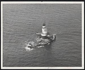 Sakonnet Light astride the Little Cormorant Rock at Sakonnet river at Little Compton, R. I., build in 1844 is a familiar sight to yachtsmen.