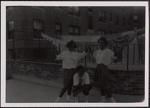 Three friends posing in Newtowne Court