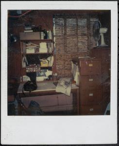 Photograph of desk and file cabinet workspace