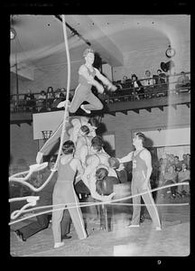 SC gym team vaulting over a stack of gymnasts