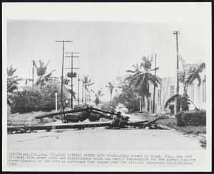 Cleo Litters Street with Poles--This street in Miami, Fla., was left littered with power poles and transformers which was partly responsible for the almost complete power blackout of the city as hurricane Cleo passed over the city.