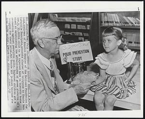 Operation Lollypop Ends--I.B. McFarland, chairman of Houston Chapter of the National Foundation for Infantile Paralysis, presents cluster of lollypops to Connie Barlow, 5, 33,000th child to be injected here in historic tests aimed at establishing the effectiveness of gamma globulin as a protection against paralytic polio. Injected children got a lollypop for their pains, but Connie hit jackpot because she drew lucky number.
