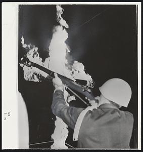 Guard Fires a Salute in front of burning cross at Klan rally at Rising Sun, Md., honoring two dead Klan leaders, Dan Burros, New York’s Grand Dragon, and Matt Murphy, Alabama attorney.