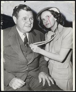 Discharged but back to Work - Babe Ruth, recently discharged from the hospital, returns to work as a movie actor in Hollywood, with actress Teresa Wright applying the stethoscope as a check.