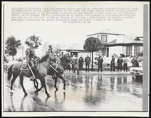 Mounted police move in as patrolmen surround Ecumenical House (R, backgd) while police search interior of the House for Black Panther George Murray, suspended English instructor at San Francisco State. Murray was ordered to show cause why his probation should not be revoked for his participation in recent disturbances at S.F. State. Warrants are also now out for Murray's arrest, on charges of inciting a riot, failure to disperse, unlawful assembly, & disturbing the peace. Ecumenical House is within a block of the campus.