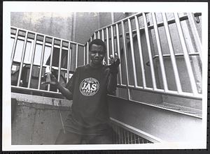 Young man posing next to stairs