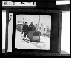 View of men driving a vehicle through snow