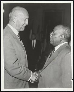 Exchange Greetings--U.S. Rep. Laurence Curtis, left, of the House Foreign Relations Committee, and President Ibrahim Abboud of Sudan exchange greetings at reception given by the African nations in Washington.