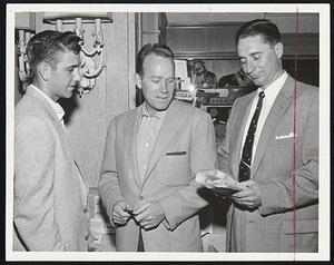 Waiting for Tonight and the first of a four-game series with the Red Sox are these Kansas City Athletics as they look up movie listings in Hotel Kenmore lobby. Left to right, infielder Cletis Boyer, trainer Jim Ewell and pitcher Lou Kretlow.