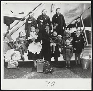 Refugee Family – Adam Gareis, his wife and their 10 children arrive in New York by plane from Germany on way to California. The family is the largest to come to the U.S. under the Refugee Relief Act.