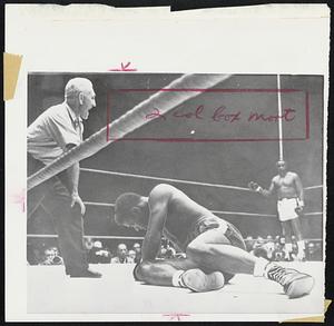 Fallen Floyd Patterson is in the process of becoming an ex-champ as referee intones the count after knockdown by Sonny Liston (in neutral corner.) the end came at 2:06 of first round of last night's bout in Chicago.