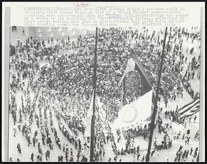 Chicago: Over 2,000 persons staged a two-hour rally in Chicago's Civic Center Plaza as part of a "Black Monday" demonstration demanding more construction jobs for Negroes 9/22. Demonstration was latest in a series by the Coalition for United Community Action, a collection of Black groups seeking more jobs in construction. Here group forms circles while chanting around the Chicago Picasso.