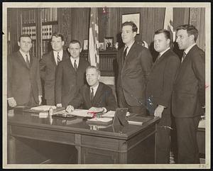 Boston College Downtown Club officers gather round Secretary of State Kevin White after he signed their corporate charter. From left, John Connors, Thomas J. Hynes Jr., John Joyce, White, Thomas Ryan Jr., Frederick Haynes and Andrew Alosi.