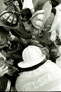 Firefighter John Chiaradonna being administered medical assistance after being rescued over the ariel from the third floor