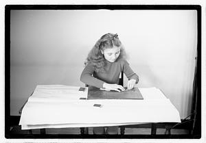 A girl matching fitting shapes in a puzzle