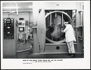 Vacuum hot press showing internal working zone, ram and electrodes