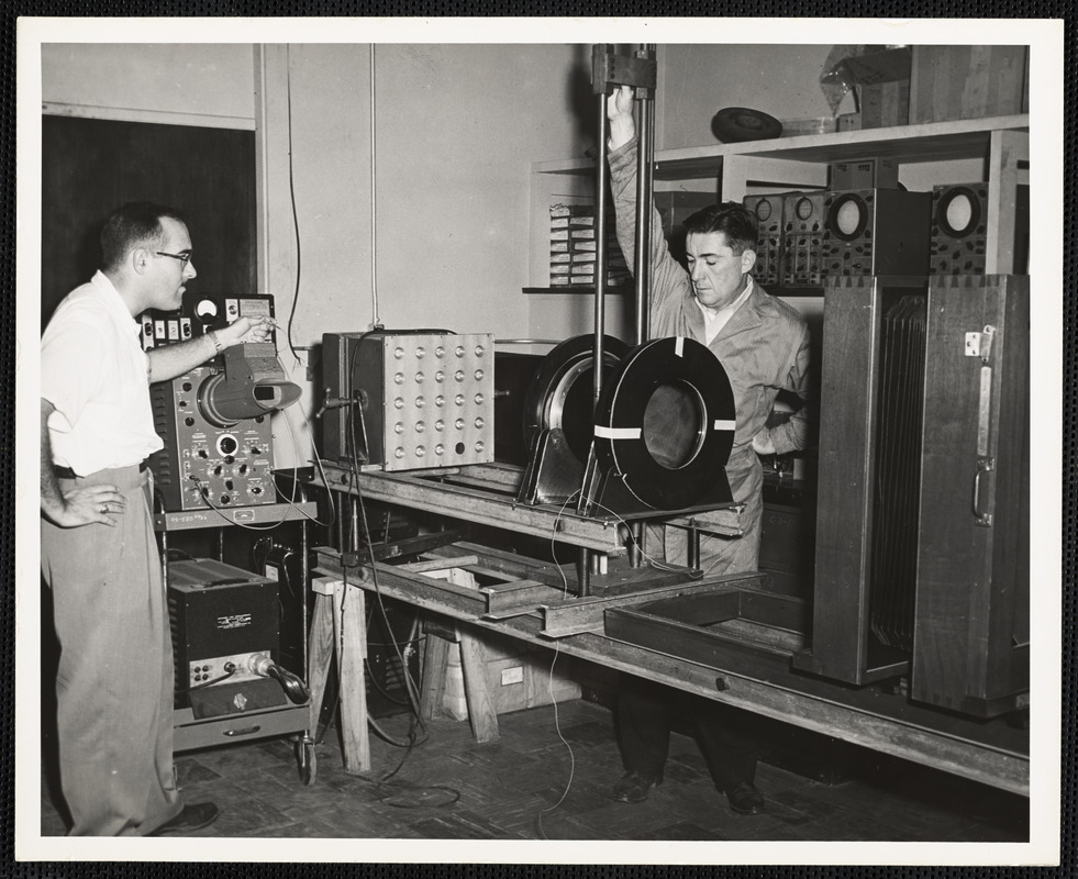 Two men operating machinery