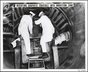 Inserting graphite crucible into induction zone