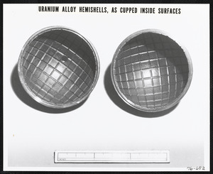 Uranium alloy hemishells, as cupped inside surfaces