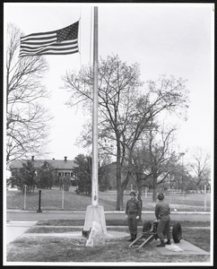 Military officers by flagpole