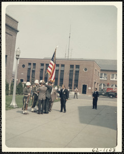 Military men holding flag