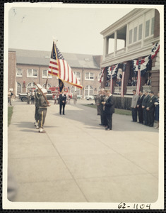 Military men holding flag