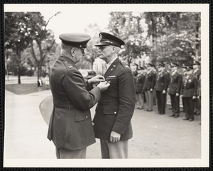 Officer pinning soldier at ceremony