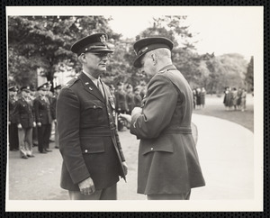 Officer pinning soldier at ceremony