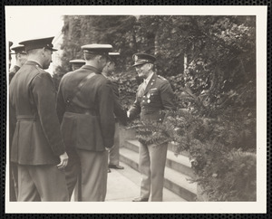 Military officers shaking hands at ceremony