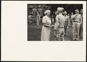 Soldier shaking woman's hand