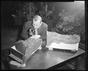 Man looking at meterorite